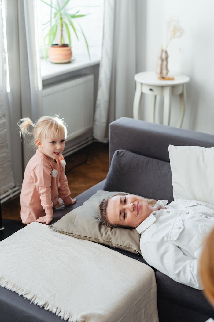 Father and daughter sharing a playful moment in a cozy living room with natural light.